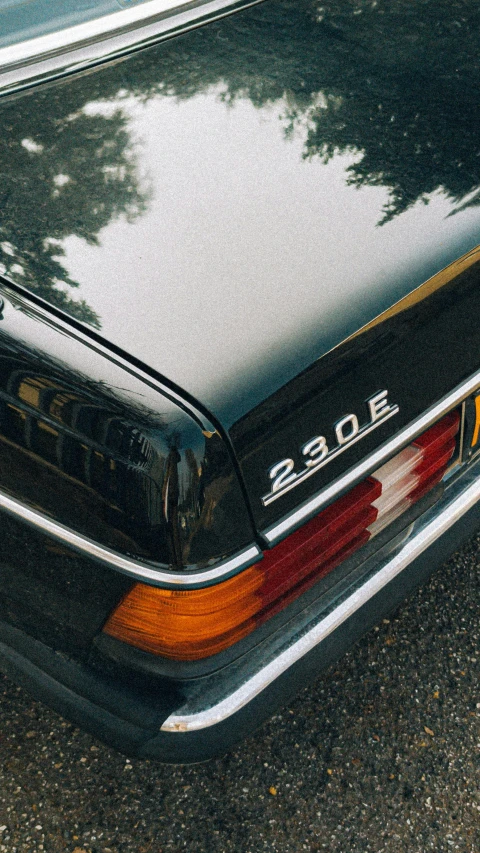 the front end of a classic car parked on a street