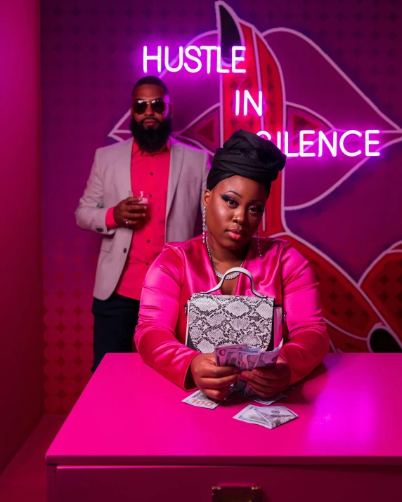 man standing in front of a pink lit desk