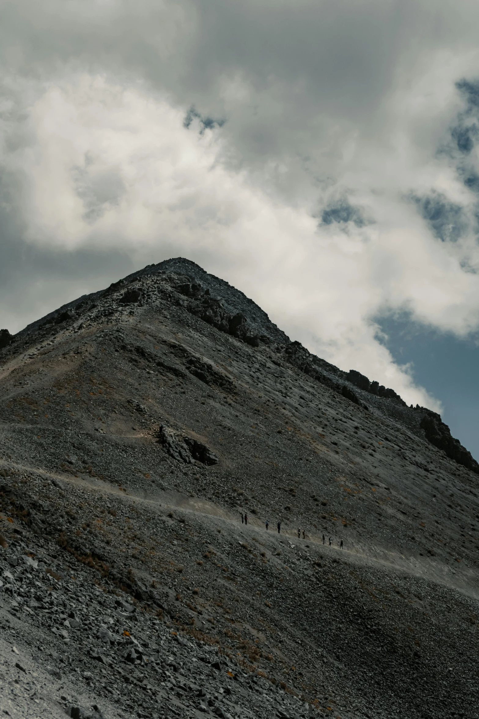 people on a mountain near some rocks