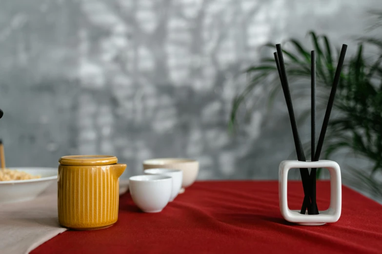 a red table topped with bowls and dishes