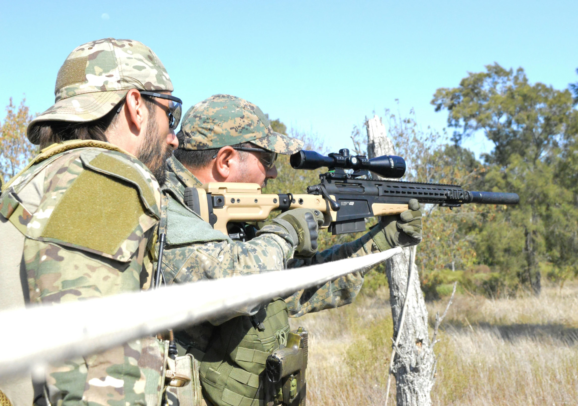 two men with camouflage paint holding guns