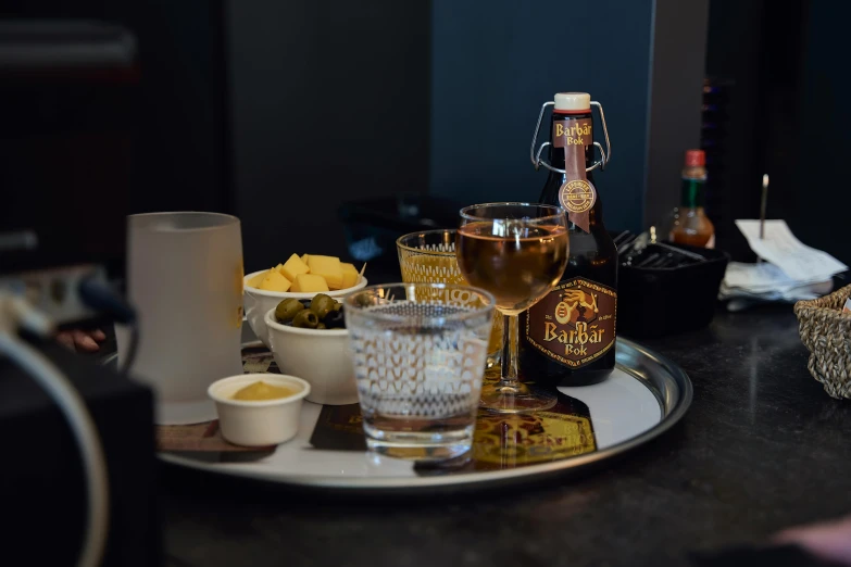 a glass plate with drinks and bottles on it