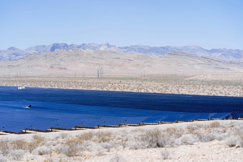 mountains are in the background and there is a lake with many tiny dots on it