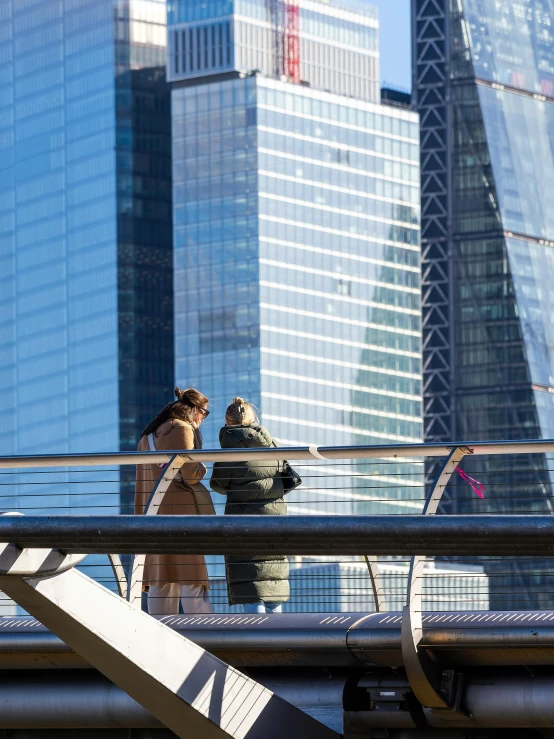 a woman walking down a street past tall buildings