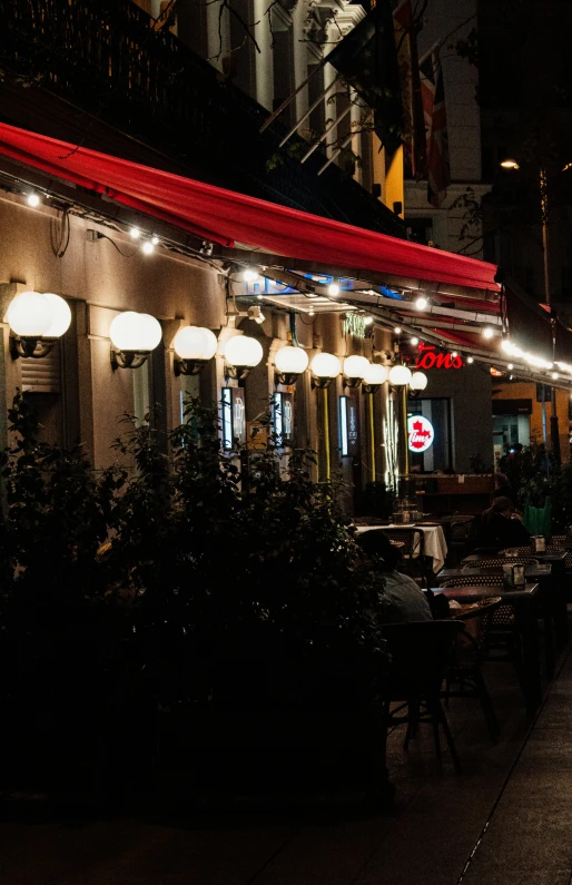 an outside cafe lit up with bright lights