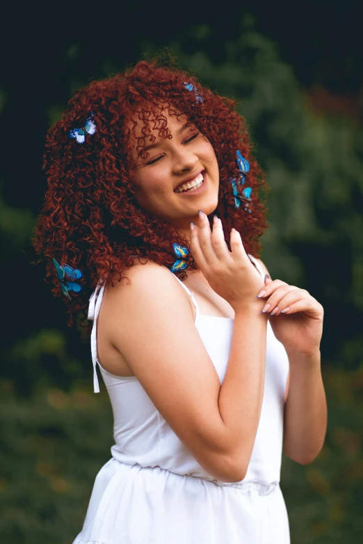 a smiling woman with erfly wings on her neck