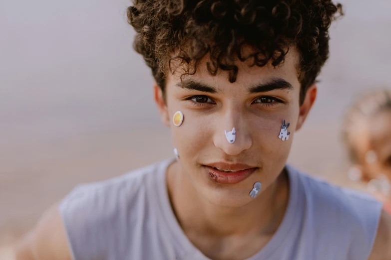 a young man with the letters i and j on his nose