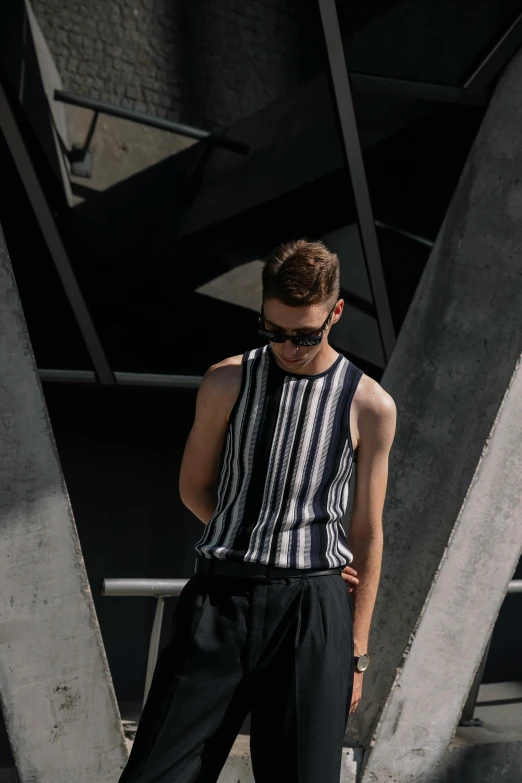 young man in black pants and white shirt wearing sunglasses