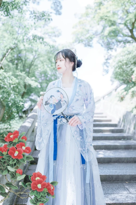 a woman in a kimono holds a fan