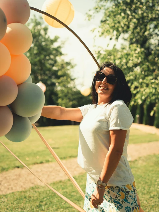 a woman is posing with a bunch of balloons