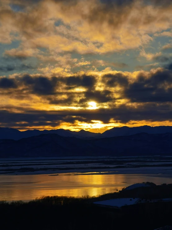 a po taken from a shoreline overlooking a mountain range