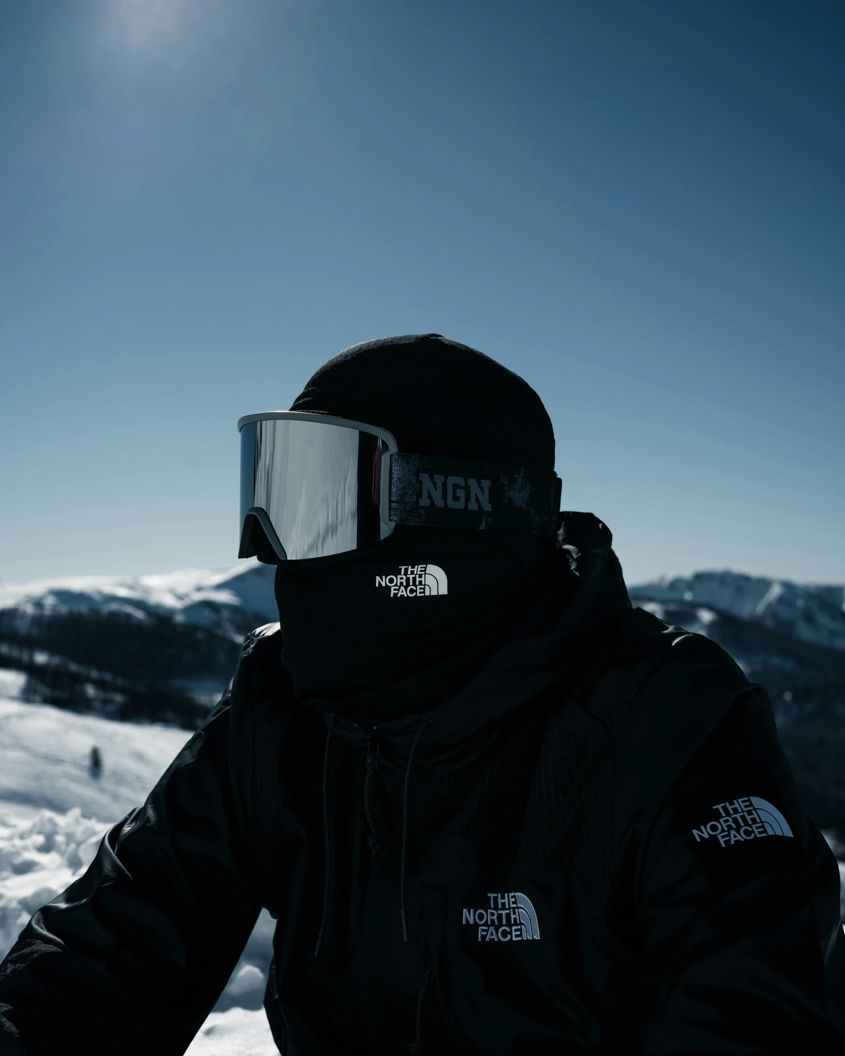 a man wearing a helmet on top of a snowy slope