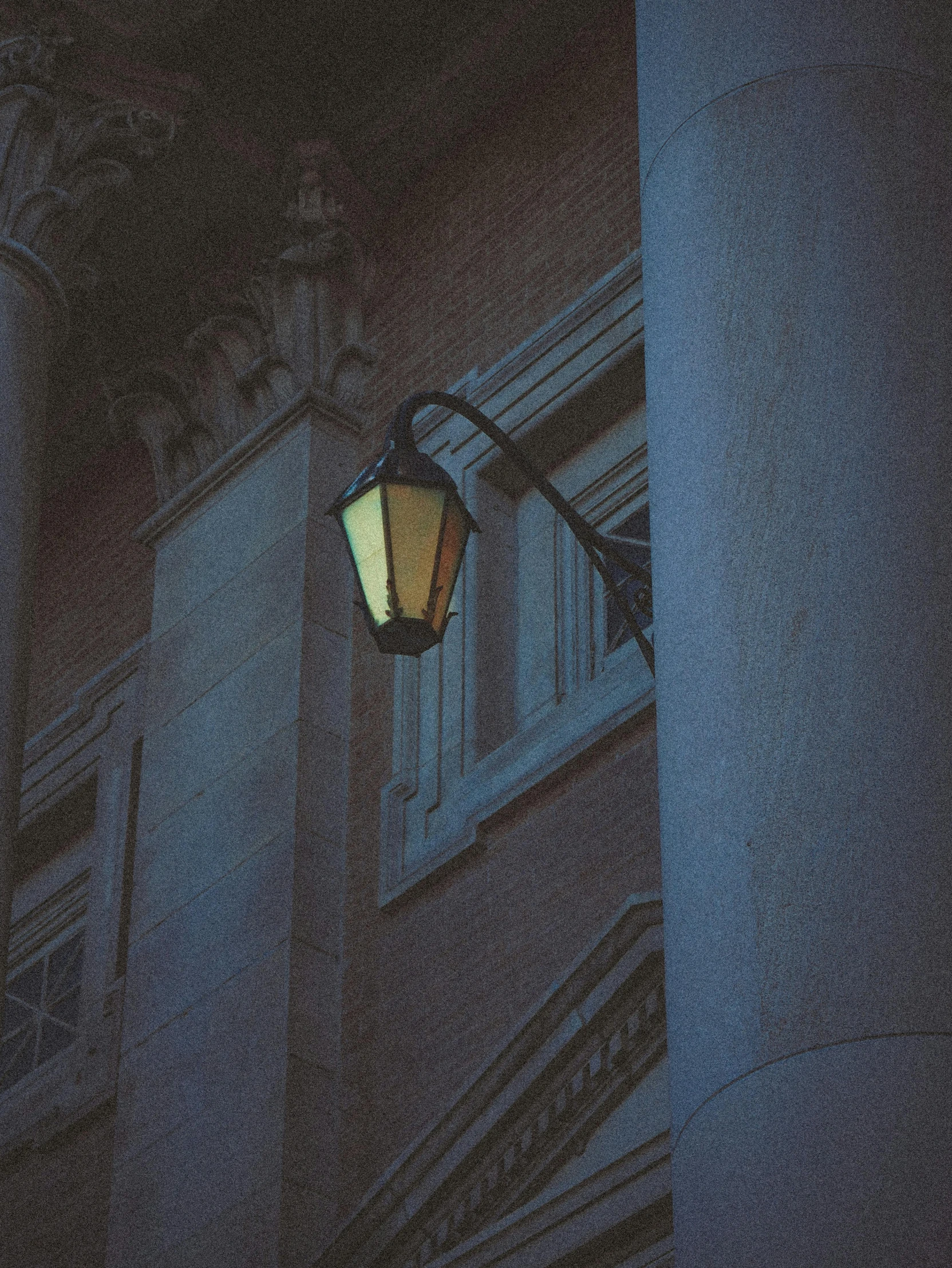 the outside of an apartment building lit up at night