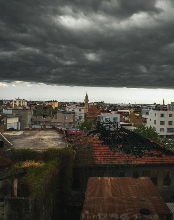 a dark storm is passing over a city