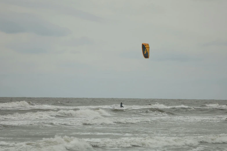 a person in the water with a kite in the air