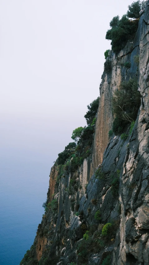 a person walking along the edge of a steep cliff