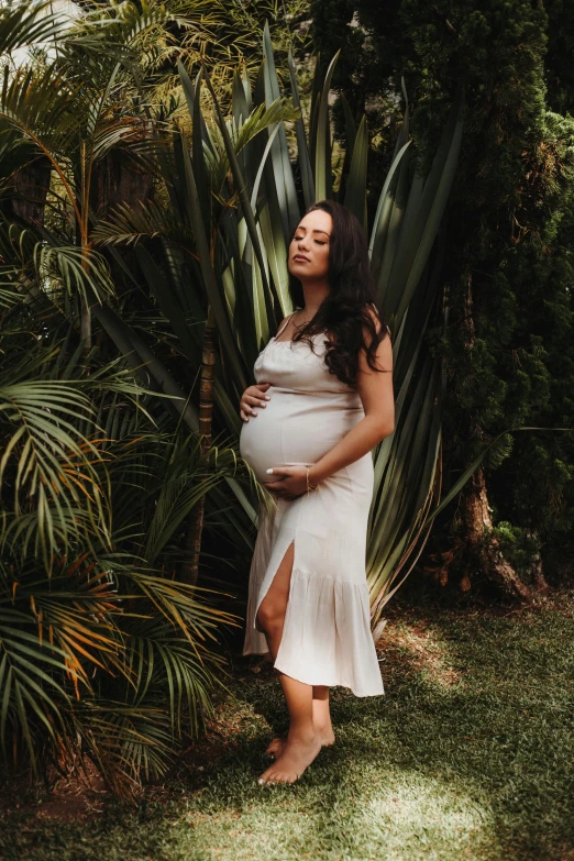 a woman is posing in front of plants