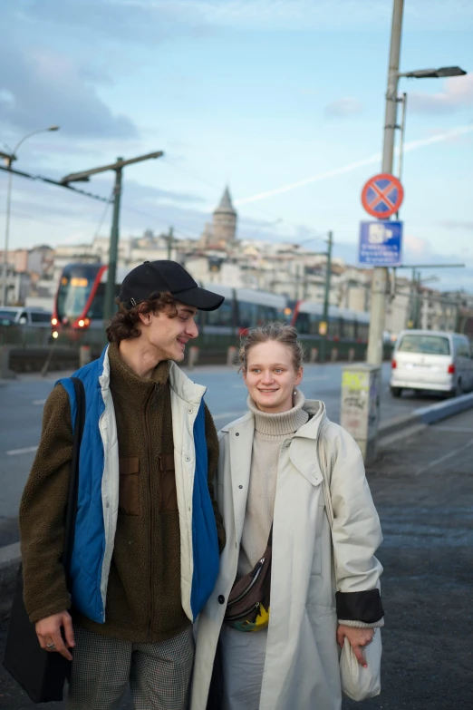 a man and woman walking down a street