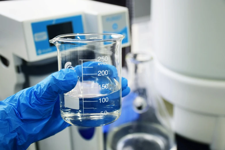 a hand holding a test tube filled with liquid