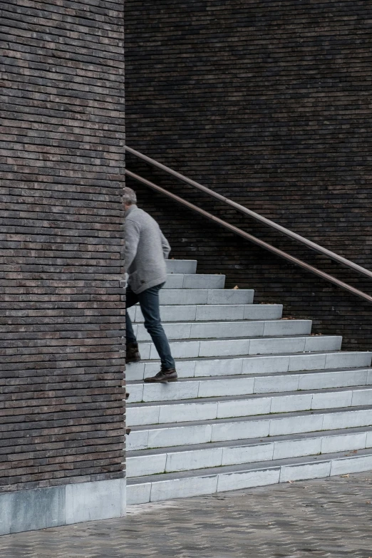 the man is walking up the stairs on the street