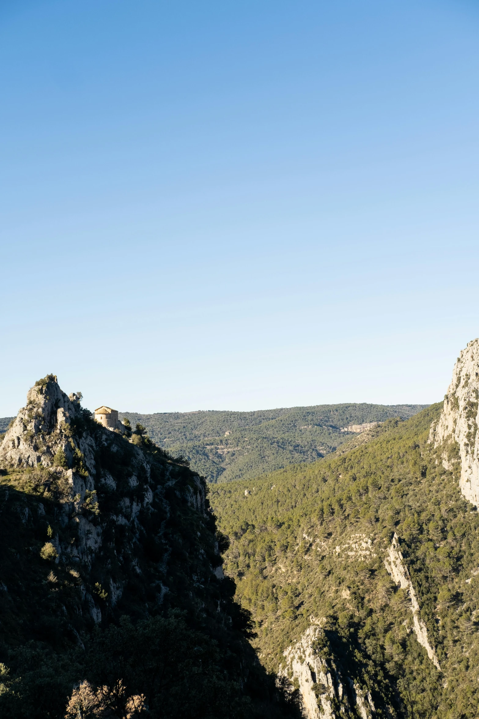 an area that has some rocks, trees and mountains in it