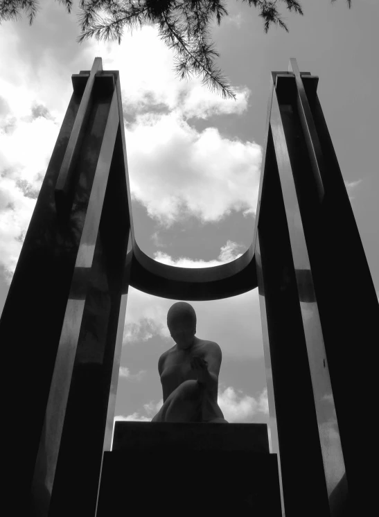 a man is sitting and posing in a black and white po