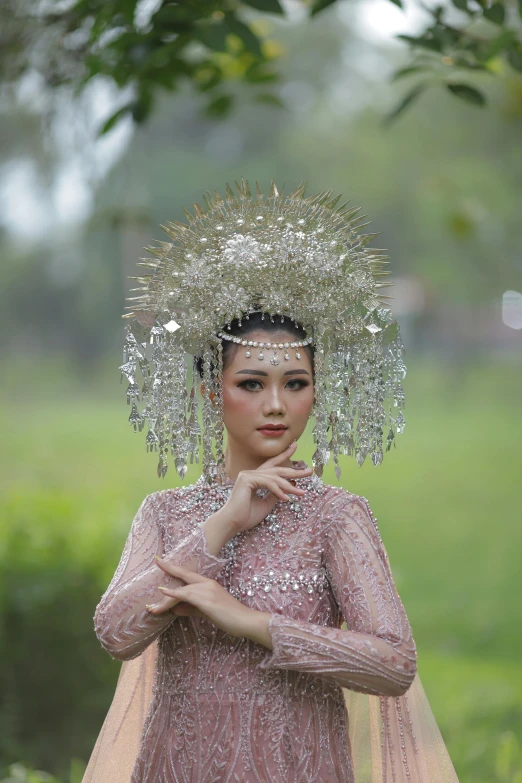 a woman with a long dress and a veil on her head