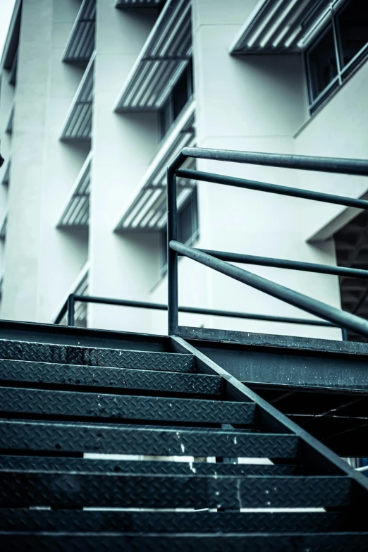 a stairwell near a building with white balconies