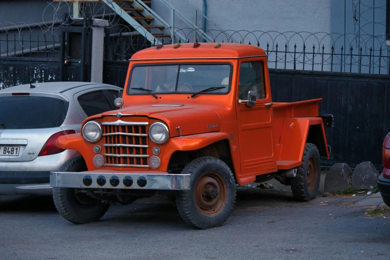 an orange truck parked on a city street