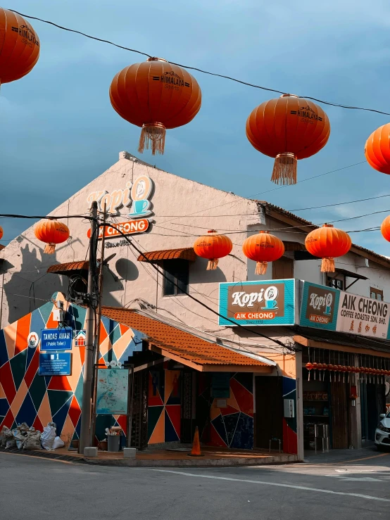 a large building with many orange lanterns hanging on the side of it