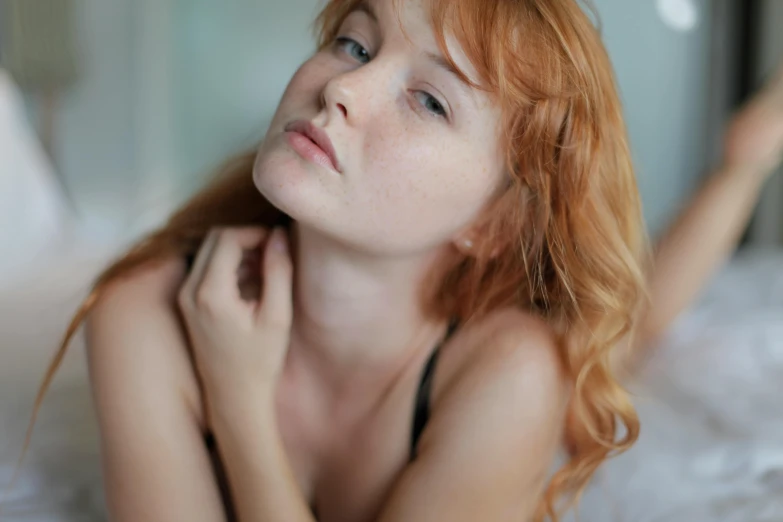 a close up of a woman on a bed