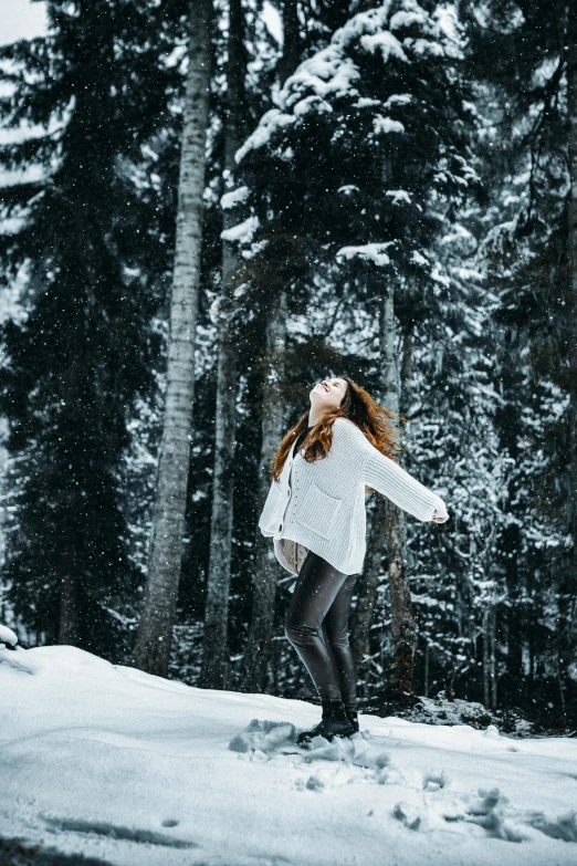 a woman in the snow wearing tight black pants