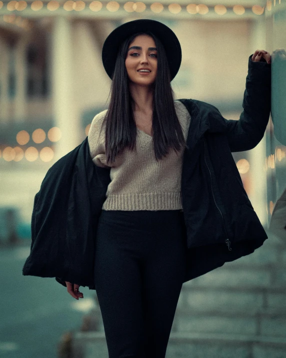 a woman walking down a street next to a building