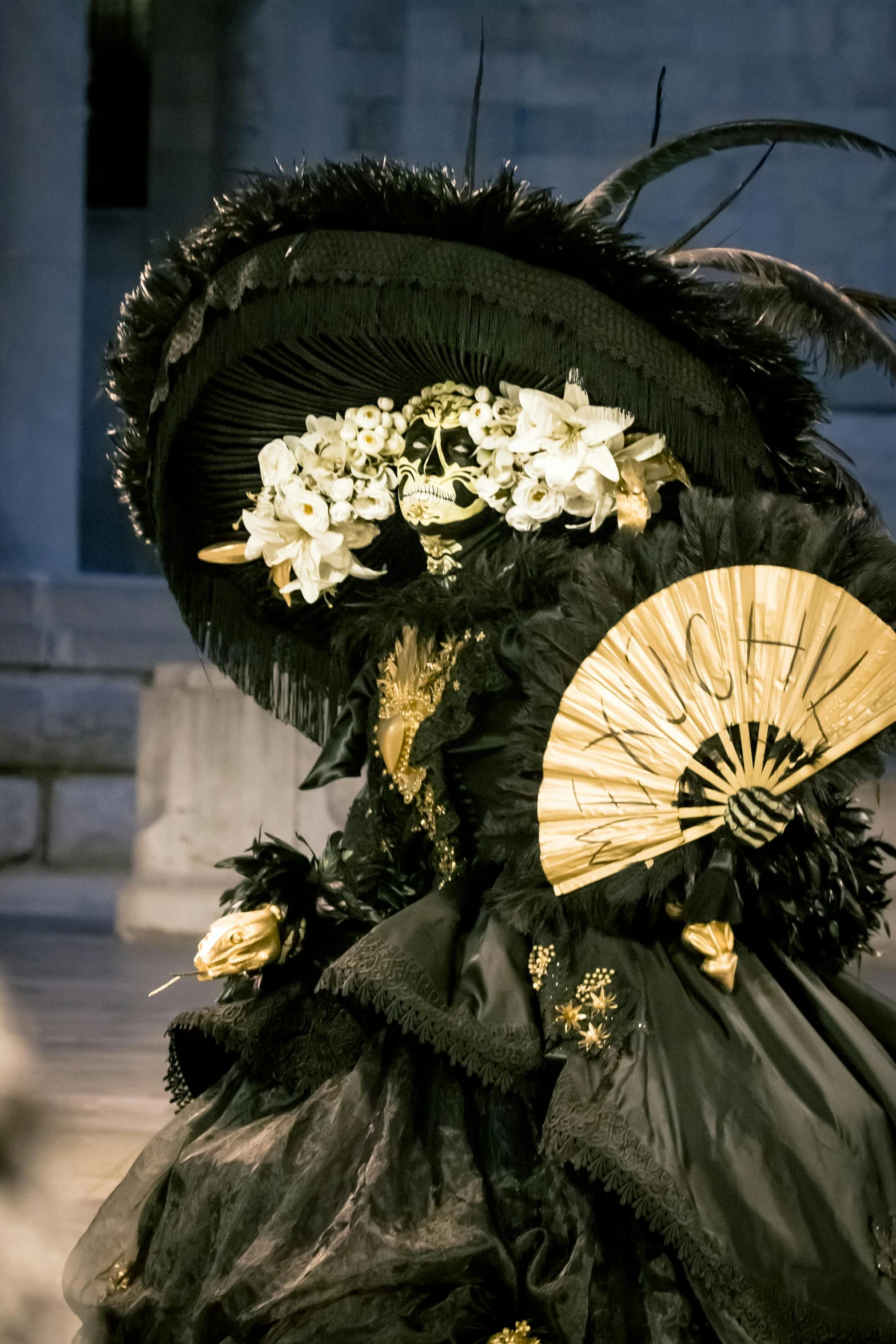 there is a woman in an elaborate dress with a fan on her head