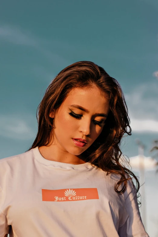 a woman with long hair wearing a white shirt