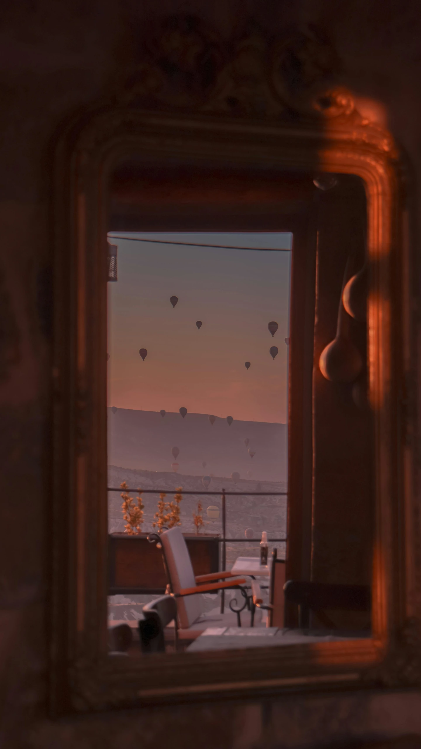 a mirror on top of a wall near a desk