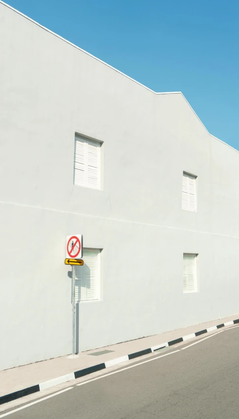 the corner of an empty street with a no parking sign