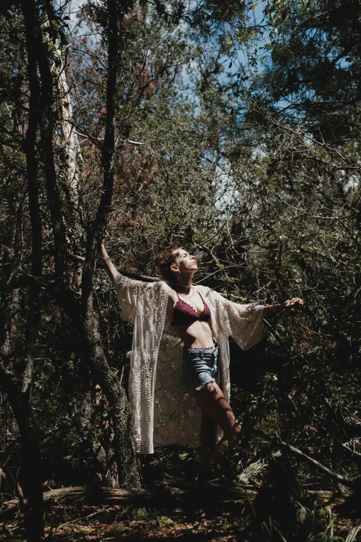 a woman is in the woods posing