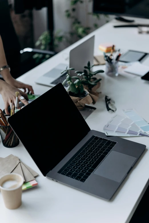 a woman working on an open laptop computer