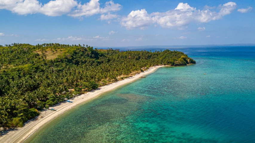 a small island is next to a beach on the ocean