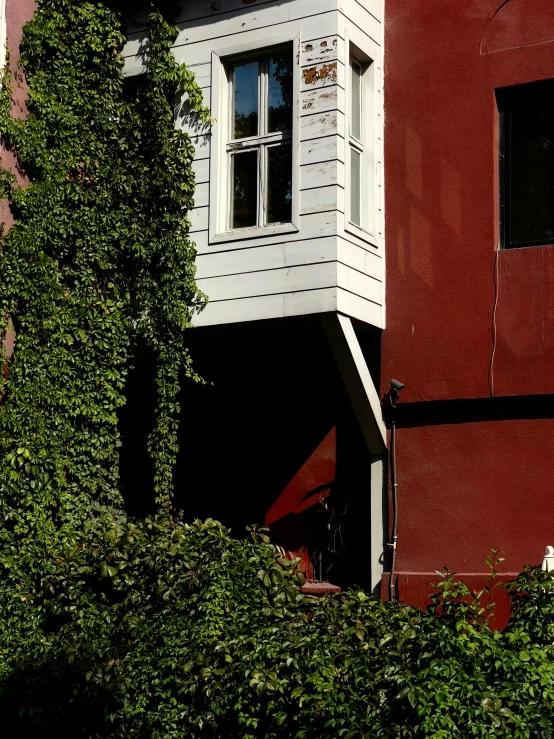 a small clock tower near a red building