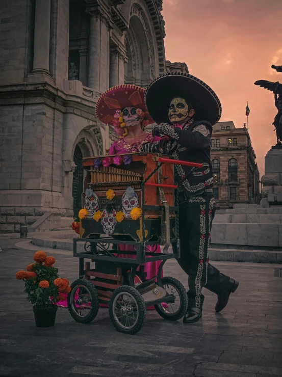 an individual dressed in costume standing beside a cart