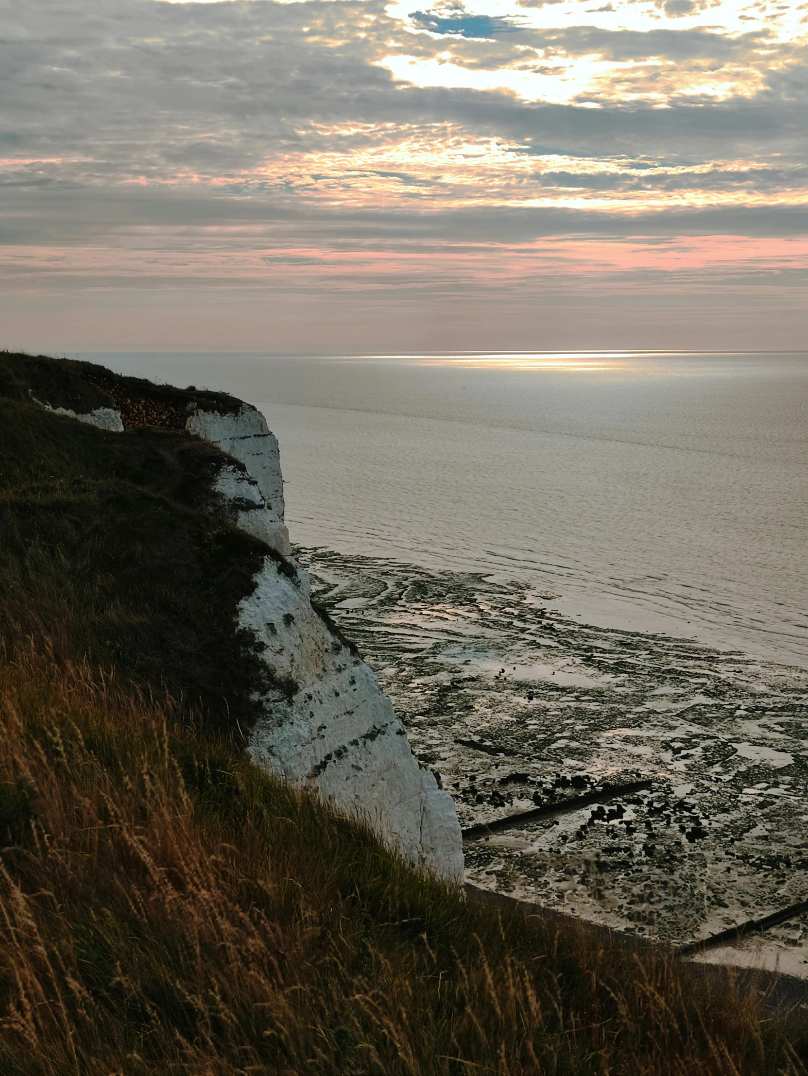 a view of the ocean with cliffs along the shore