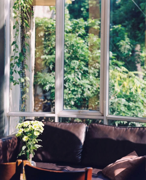 the couch has flowers in it next to a window