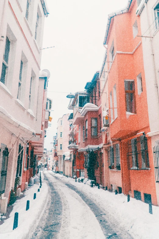 a snowy street lined with lots of building