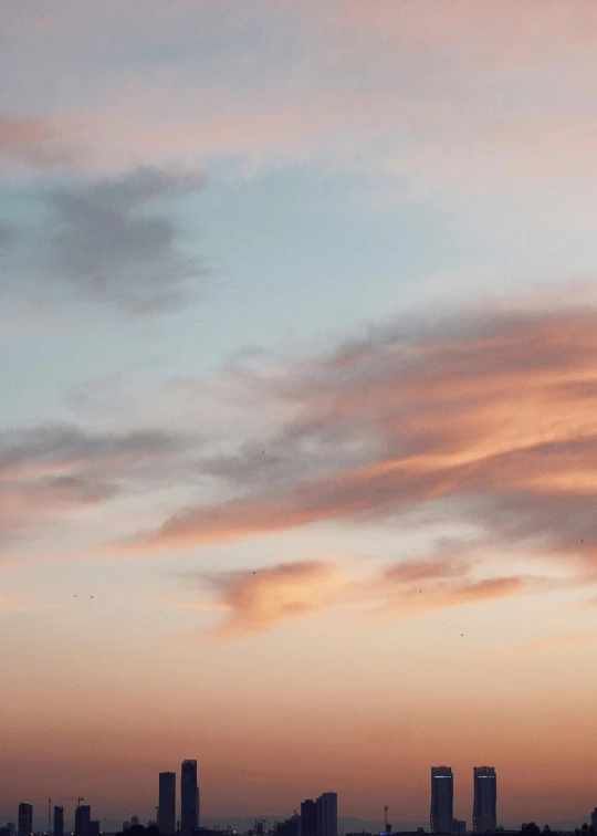 a plane flying through the sky with a few clouds