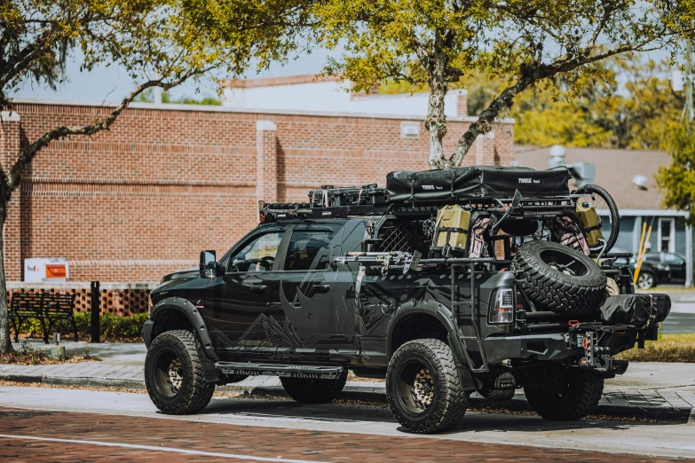 a jeep with two large tires parked on the street