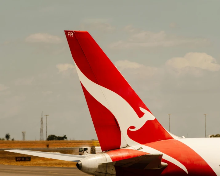 a very big red airplane that is on the runway
