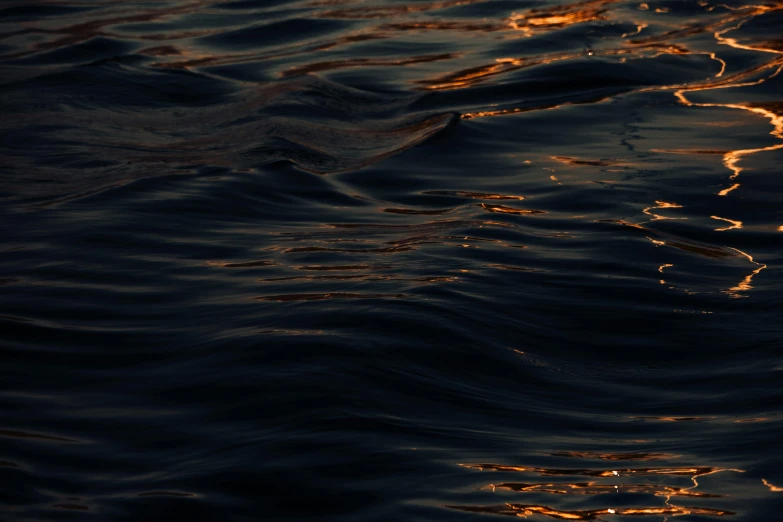 a large body of water with ripples on the surface