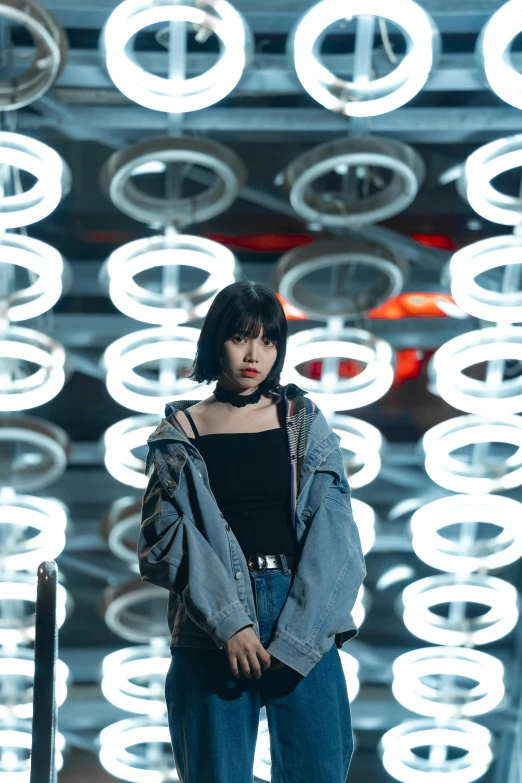 a model stands in front of a display of circles